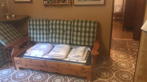 a couch with some pillows on it in a room at da Nicola e Greta in Miroglio