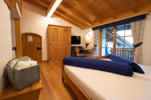 a bedroom with a bed and a large window at Crusch Alba Studio auf der Strassenseite Sta Maria in Sta Maria Val Müstair