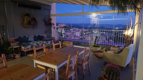 a room with a table and chairs and a large window at La Terrazza di Empedocle in Agrigento