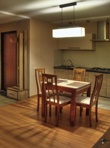 a kitchen with a table and chairs in a room at Квартира в центре города in Vinnytsya
