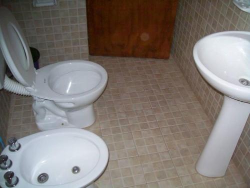 łazienka z toaletą i umywalką w obiekcie Cabañas Alma Comechingon w mieście Villa Cura Brochero
