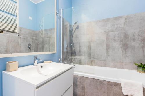 a bathroom with a white sink and a shower at Milan Retreats in Milan