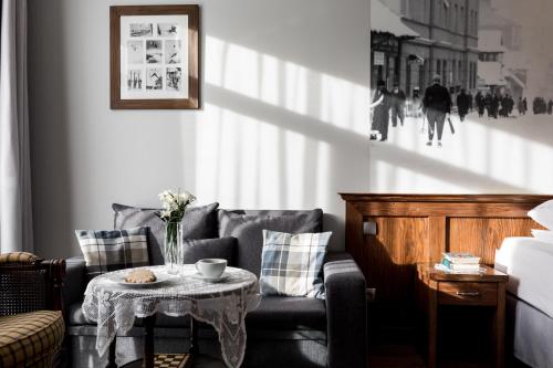 a living room with a couch and a table at Apartamenty Folk & Art Krupówki 25 in Zakopane