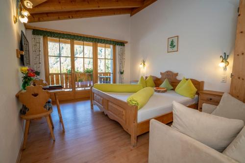 a living room with a bed and a couch at Hotel Crusch Alba Sta Maria in Sta Maria Val Müstair