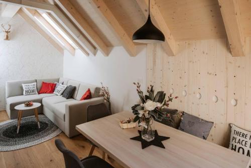 a living room with a couch and a table at Apartment Špica - Private parking in Kranjska Gora