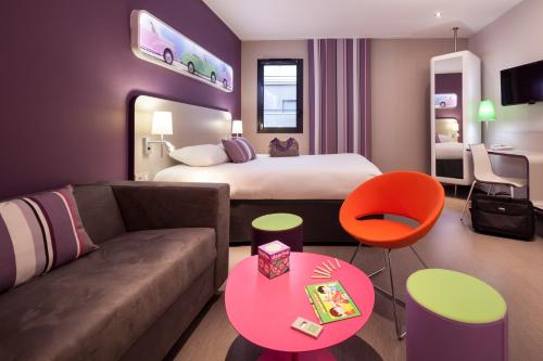 a hotel room with a bed and a couch at ibis Styles Montbéliard in Montbéliard