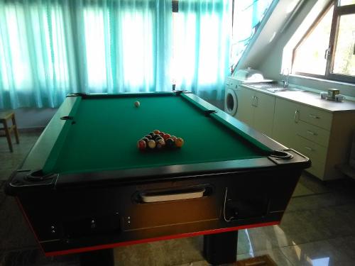 a green pool table in a room with afits at Vila Sula Guesthouse in Durrës
