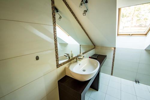 a small bathroom with a sink and a window at Dom w lesie in Łask