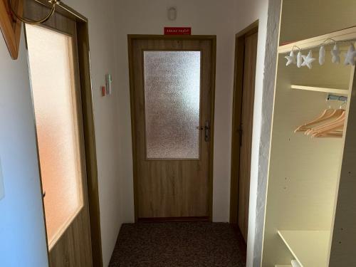 a hallway with a door and a window in a closet at Retrohaus in Liptovský Mikuláš