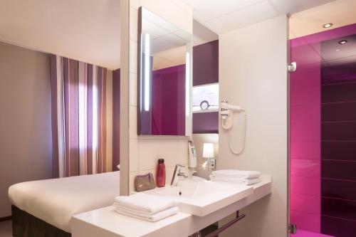 
a bathroom with a sink and a mirror at ibis Styles Montbéliard in Montbéliard
