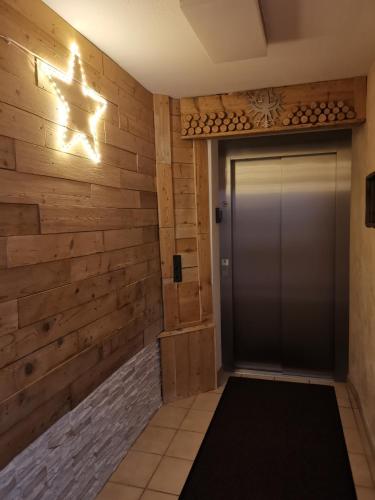 a hallway with a door with a wooden wall at Ferienlandhaus Höfer in Fulpmes