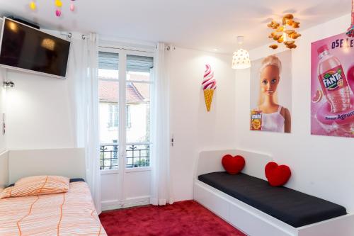 a bedroom with a bed and two hearts on the wall at Bonjour Paris in Paris