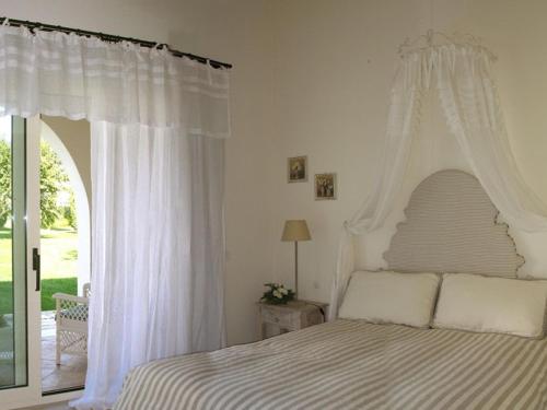 a bedroom with a white bed with a canopy at Casa Freda in Foggia