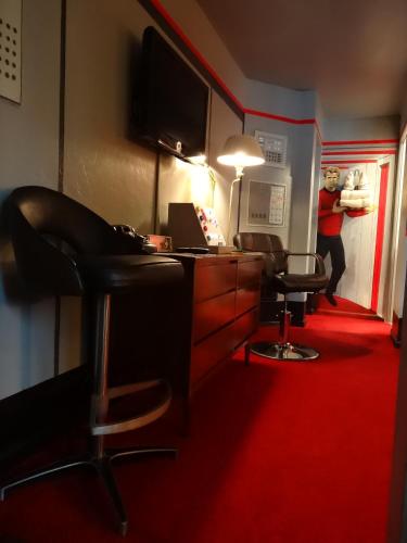a person in a room with a desk and a chair at The Star Trek - USS Enterprise Room at the Itty Bitty Inn in North Bend
