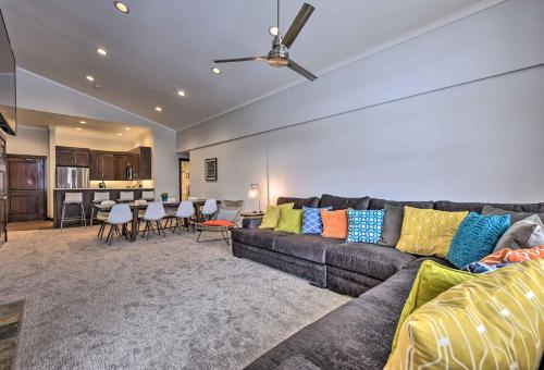 a living room with a couch with colorful pillows at Slopeside Solitude Condo - Walk to Ski Lifts! in Solitude
