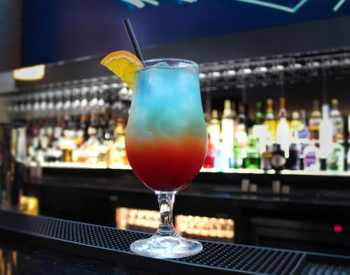 a drink in a glass sitting on a bar at Crowne Plaza London Heathrow T4 by IHG in Hillingdon