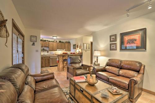 a living room with leather couches and a table at Cozy Angel Fire Condo Less Than Half Mi to Resort! in Angel Fire