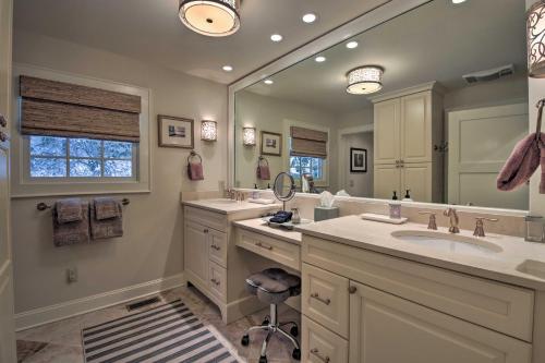 a bathroom with two sinks and a large mirror at Lush Mirror Lake Cottage Rental with Private Deck in Highlands