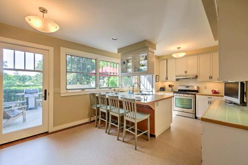 a kitchen with white cabinets and a large window at Southwest Harbor Home-3 Min to Acadia Natl Park in Southwest Harbor