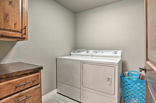 a washer and dryer in a small kitchen at Lead Family Home with Hot Tub, 2 Mi to Deer Mountain in Lead