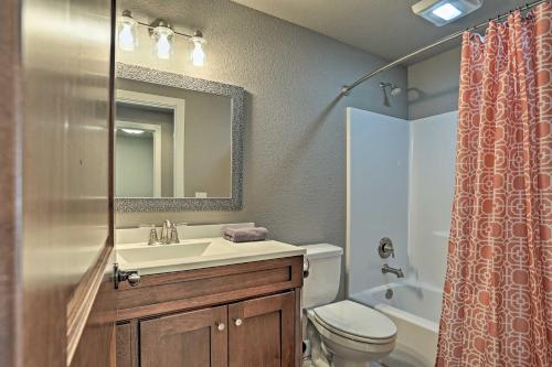a bathroom with a sink and a toilet and a mirror at Lead Family Home with Hot Tub, 2 Mi to Deer Mountain in Lead