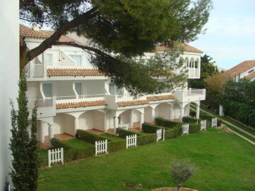 a large white house with a green yard at APCOSTAS - Complejo Al Andalus in Alcossebre