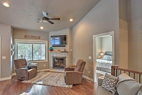 a living room with two chairs and a fireplace at Lead Family Home with Hot Tub, 2 Mi to Deer Mountain in Lead