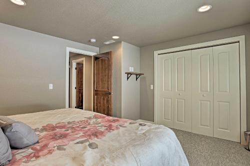 a bedroom with a large bed and a white door at Lead Family Home with Hot Tub, 2 Mi to Deer Mountain in Lead