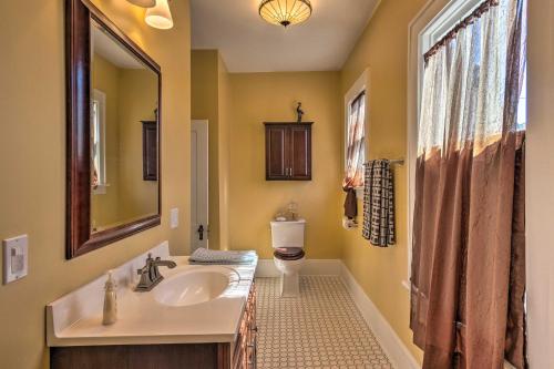 a bathroom with a sink and a toilet and a mirror at Historic Home 8 Mi to Bristol Motor Speedway in Bristol