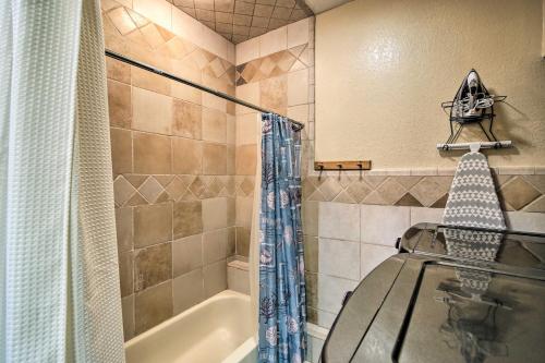 a bathroom with a bath tub and a shower curtain at Pool and Game Room Waterfront Harlingen Home in Harlingen