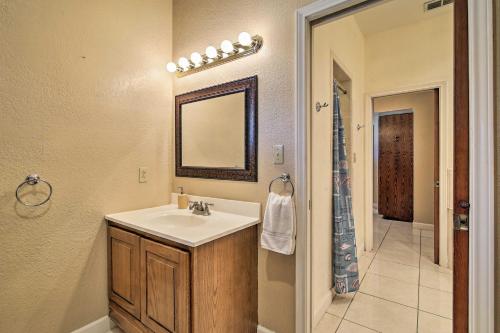 a bathroom with a sink and a mirror at Pool and Game Room Waterfront Harlingen Home in Harlingen