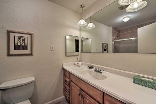 a bathroom with a sink and a toilet and a mirror at Pet-Friendly Missouri City Home with Fenced-In Yard! in Missouri City