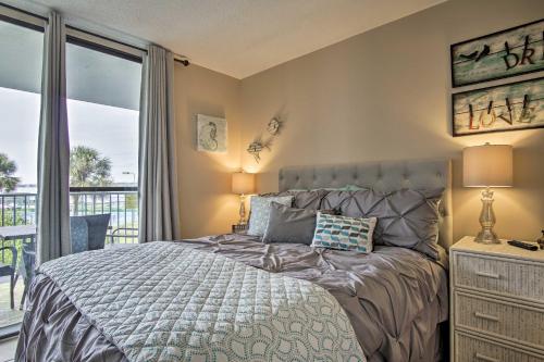 a bedroom with a bed and a balcony at Gulf Shores Getaway with Pool, Spa and Beach Access! in Gulf Shores