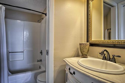 a bathroom with a sink and a mirror and a toilet at Gulf Shores Getaway with Pool, Spa and Beach Access! in Gulf Shores