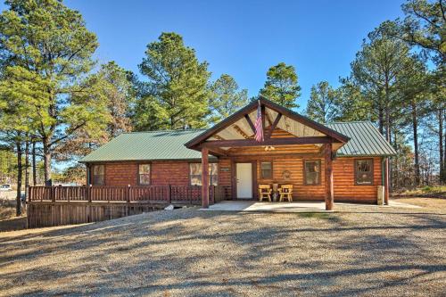 a log cabin with a porch and a deck at Broken Bow Cabin with Hot Tub and Covered Deck! in Stephens Gap