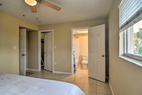 a bedroom with a bed and a window and a bathroom at Cozy Indian Rocks Beach Condo - Steps to Beach! in Clearwater Beach
