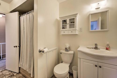 a white bathroom with a toilet and a sink at Family-Friendly Wildwood Townhome about 3 Mi to Beach in Wildwood