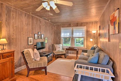 a living room with wooden walls and a ceiling at Cottage with Private Pool - Walk to Lake Wales! in Lake Wales