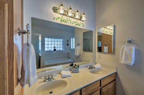a bathroom with two sinks and a large mirror at Patio and Mtn Views Tranquil Sedona Gem in Sedona