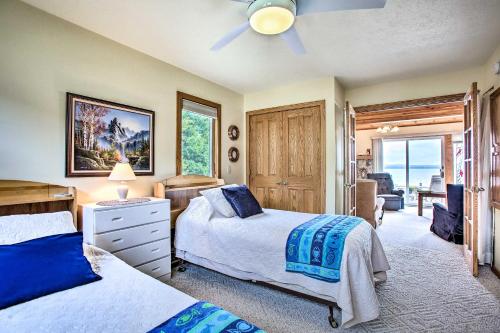 a bedroom with two beds and a ceiling fan at Cedar Cottage, Private Beach on Lake Leelanau in Cedar