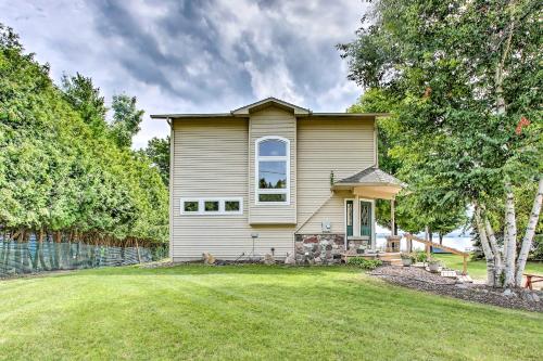 a small white house with a large yard at Cedar Cottage, Private Beach on Lake Leelanau in Cedar