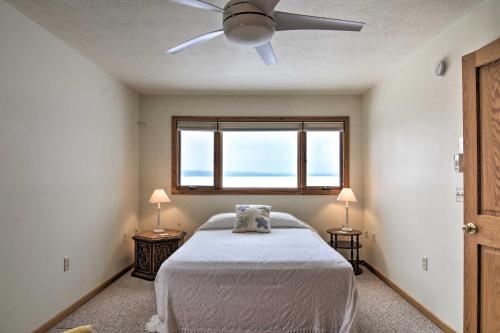 a bedroom with a bed and a ceiling fan at Cedar Cottage, Private Beach on Lake Leelanau in Cedar