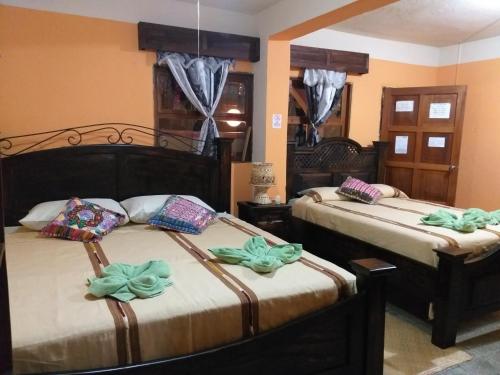 a bedroom with two beds with bows at Hospedaje El Viajero in Panajachel