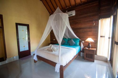 Ein Bett oder Betten in einem Zimmer der Unterkunft Timbool Bungalow