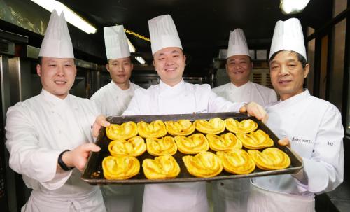 a group of chefs holding a tray of food at Shanghai Park Hotel - Hudec Excellent Historical Building - Priority Access for Classic Butterfly Cookies Without queuing to guests in Shanghai