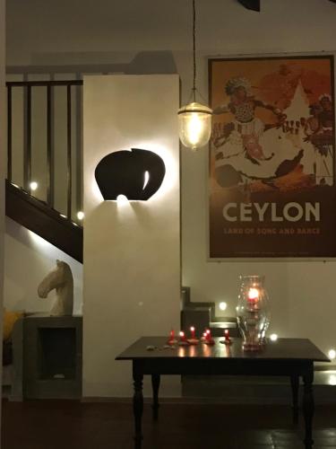 a dining room with a table and a pendant light at Saltasia Boutique Beach Villa in Mirissa
