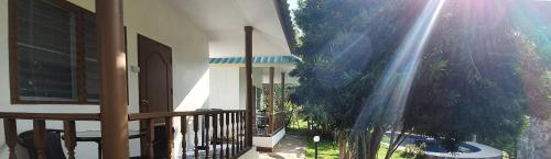 a balcony of a house with a fence and plants at Green Canyon Resort in Lamai