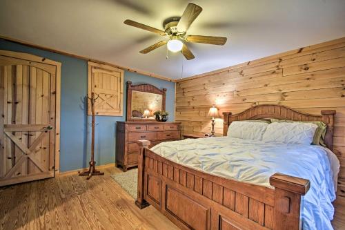 a bedroom with a bed and a ceiling fan at Cozy Amish Country Cabin on Shipshewana Lake! in Shipshewana