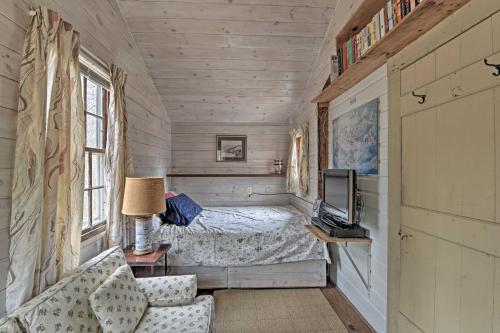 a small bedroom with a bed and a television at Cozy Vineyard Haven Cottage Less Than 1 Mi to Beach! in Vineyard Haven
