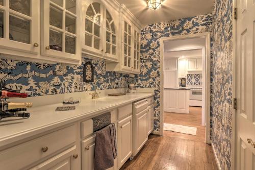 a kitchen with white cabinets and blue and white wallpaper at Waterfront Vacation Rental Near Louisville! in Prospect